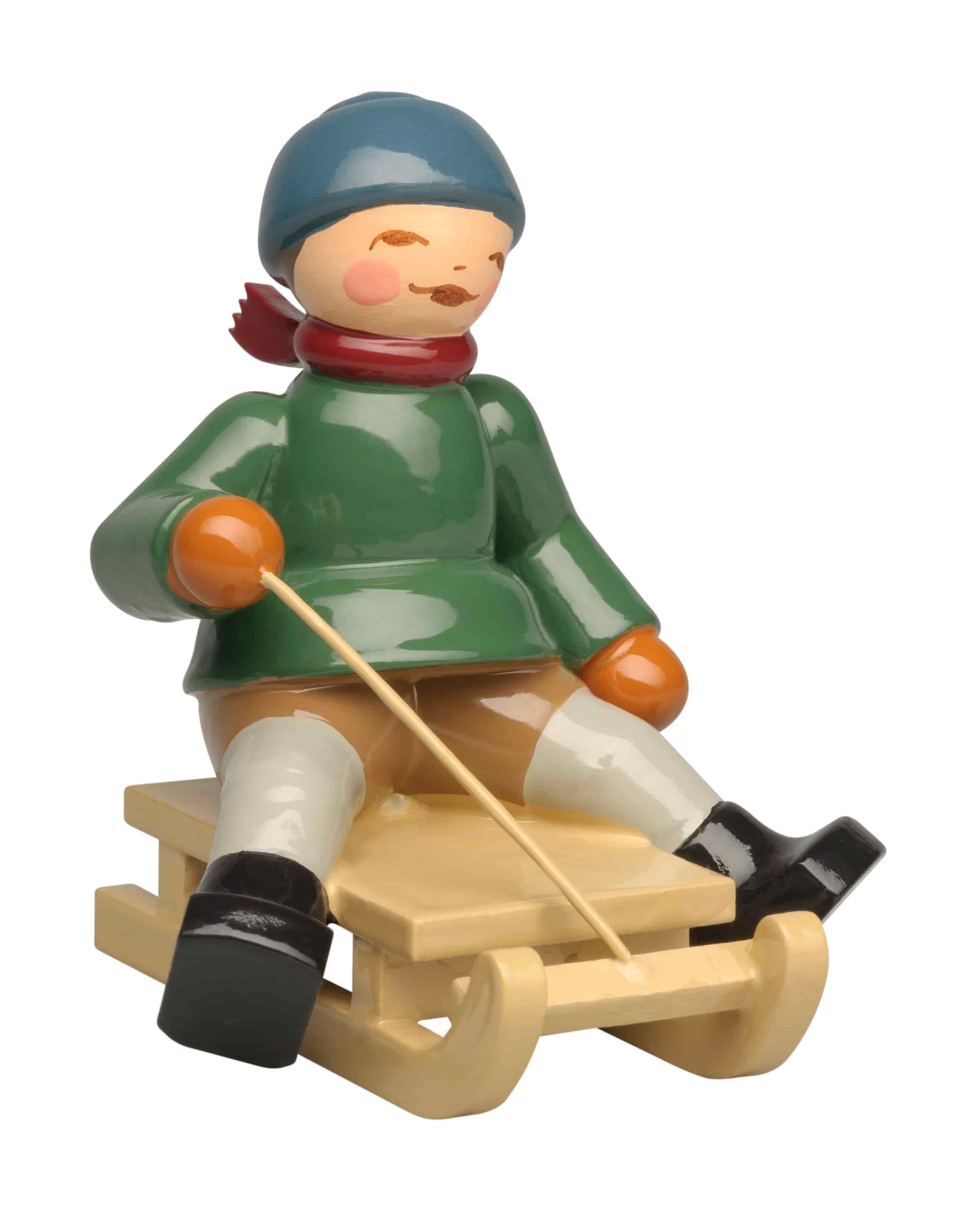 Winterkinder Junge auf Schlitten